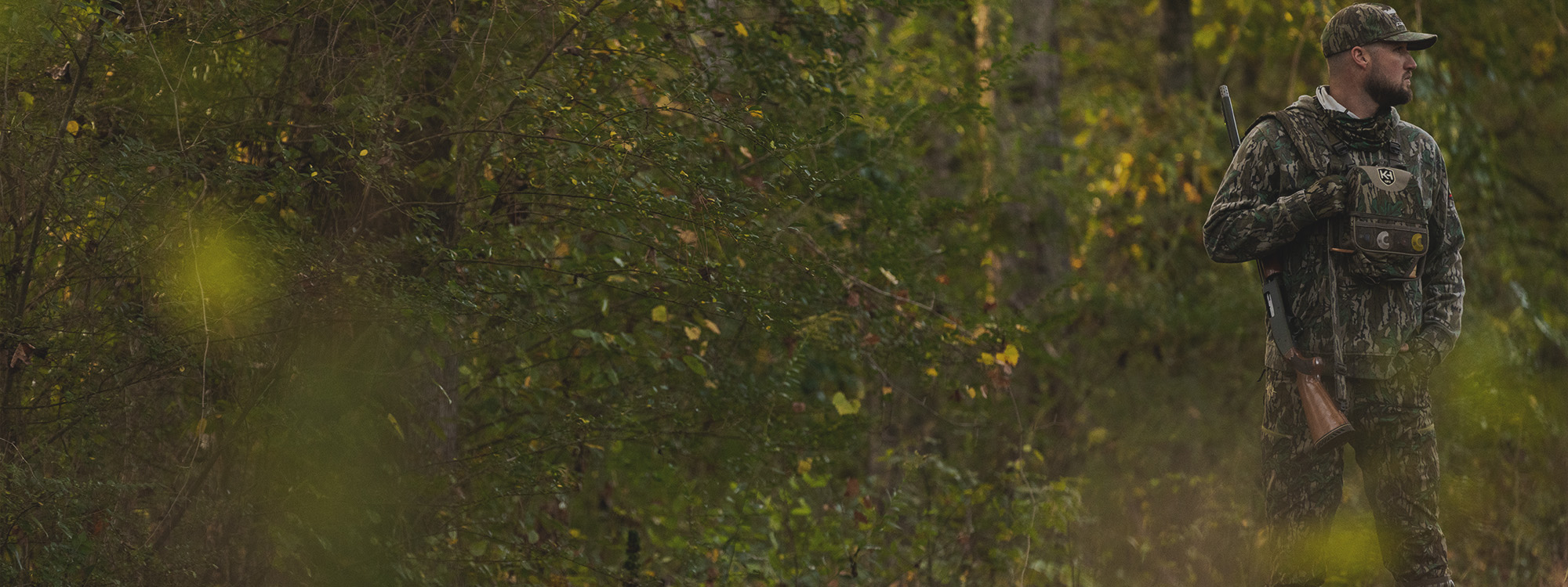 An outdoorsman surveying open mountain terrain